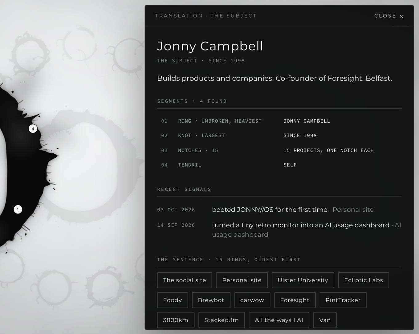Heptapod B in JONNY//OS: part of a black ink logogram on white, and a translation panel in Montserrat giving Jonny Campbell, the logogram's four segments, recent signals and its fifteen rings, oldest first.