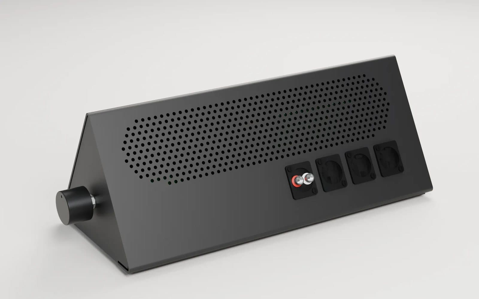 A render of the black enclosure from behind: a grid of vent holes, four connector cut-outs and the volume knob on the side.